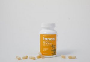 Tanasi CBD capsules and bottle on white background