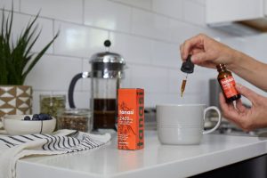 Tanasi CBD Tincture being used in morning coffee