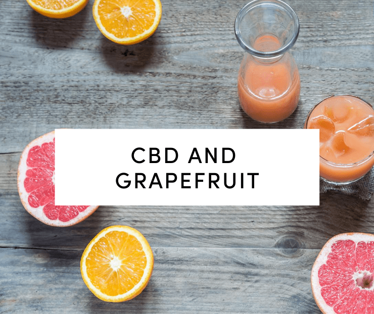 CBD and Grapefruit: Grapefruit and grapefruit juice on natural board