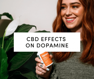 CBD Effects on Dopamine: Woman with red hair holding Tanasi CBD capsules and smiling