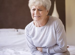 Older woman in pain from MCT oil