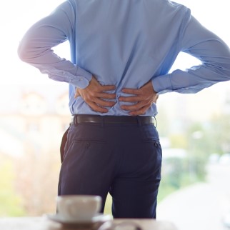 CB1 Receptors - man experiencing chronic back pain, CBD's interaction with CB1 receptors might help him