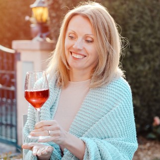CBD vs Wine - happy blonde holding a glass of wine