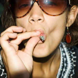 What Is Decarboxylation? - woman smoking a marijuana joint
