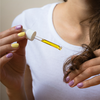 How Often Can You Take CBD Oil - woman with a dropper full of CBD