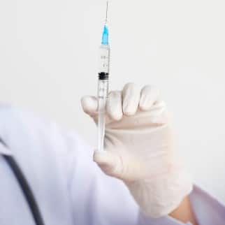 CBD Syringe - syringe in the hands of a doctor